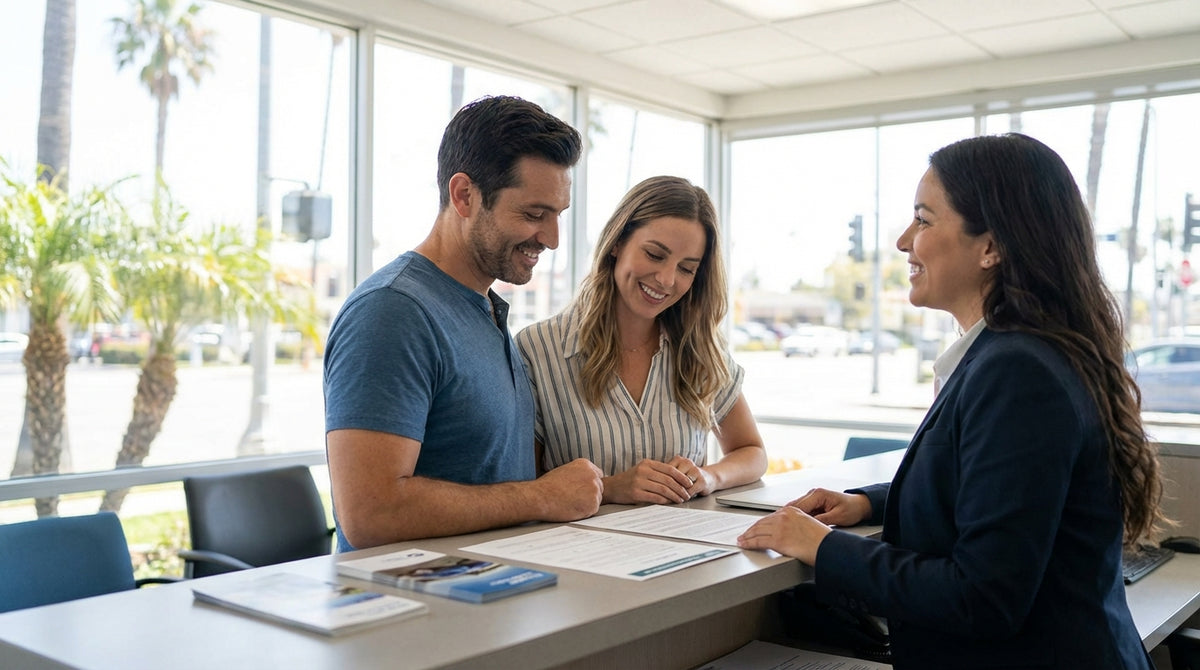 A red convertible car hire driving along a sunny, winding coastal road in California