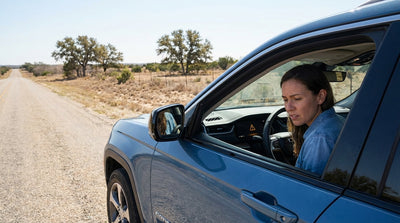 A close-up of an illuminated 'Service 4WD/AWD' warning light on the dashboard of a Texas car hire