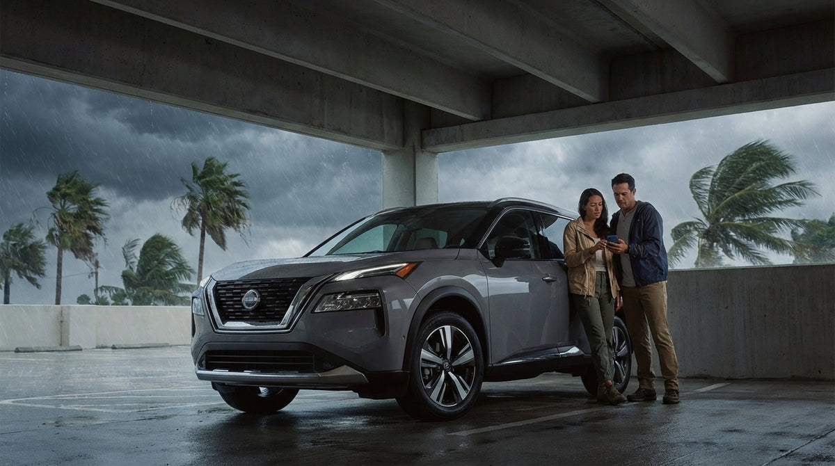 Ominous storm clouds gather over a car rental on a deserted highway lined with palm trees in Florida