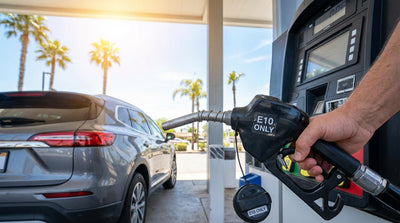 A driver stands by their car rental, looking at the different fuel options on a pump at a California gas station
