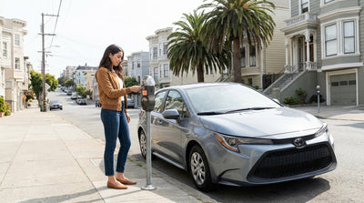 A person at a car hire counter in San Francisco hands a payment card to an agent to rent a vehicle
