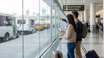 Traveler loading luggage into a car rental vehicle outside a New York airport