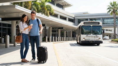 Passengers with luggage waiting for a car hire shuttle outside LAX Terminal 7 in Los Angeles