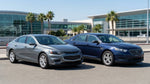 Standard sedan and full-size SUV parked outside a car rental office in the United Estates