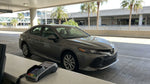 Customer handing a credit card to an agent at a car hire desk in Orlando