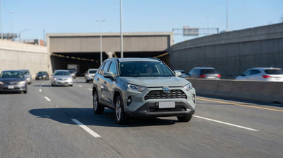 A car hire in traffic approaching the Lincoln Tunnel entrance and the clearly marked XBL bus lane