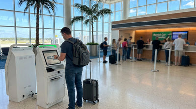 A family smiling as they walk through the Orlando airport to pick up their car rental, skipping the long line
