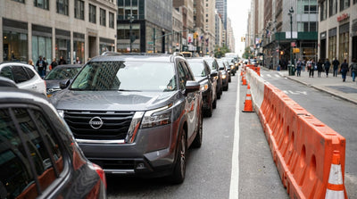 Yellow cabs and a car hire vehicle in heavy traffic on a busy street in New York City