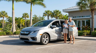 A white minivan for a family car hire parked under sunny palm trees in Florida