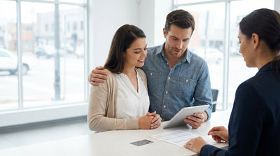 A modern sedan car rental driving on a busy street in New York with yellow cabs in the background