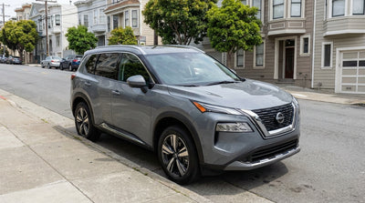 A modern car hire parked on a steep residential street with classic San Francisco homes in the background
