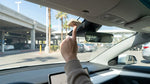 Electronic toll tag attached to the windshield of a parked vehicle in a Las Vegas airport car rental lot