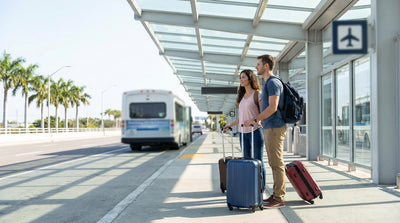 A purple car rental shuttle bus picking up passengers under a sign at LAX in Los Angeles