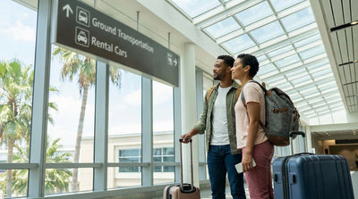 Overhead signs for car rental services guide travelers through the main terminal at Orlando International Airport (MCO)