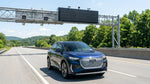 A person driving a car rental under an electronic toll gantry on a Pennsylvania highway