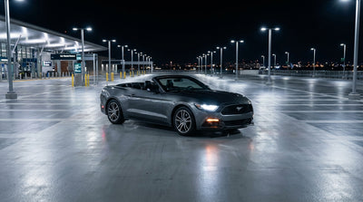The brightly lit Las Vegas airport car hire center building with cars parked outside at night