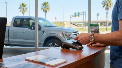 View from inside a car hire vehicle driving down a long, straight highway in rural Texas