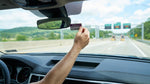 E-ZPass transponder attached to the windshield of a car rental driving on a Pennsylvania highway