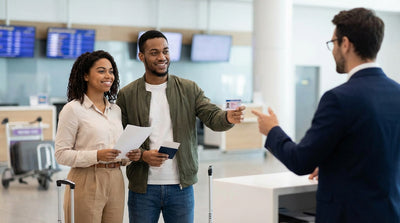 A red convertible car hire drives through the bright lights of Times Square in New York City at night