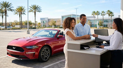 A stylish convertible car hire parked on a sunny street in Miami with iconic palm trees and art deco hotels