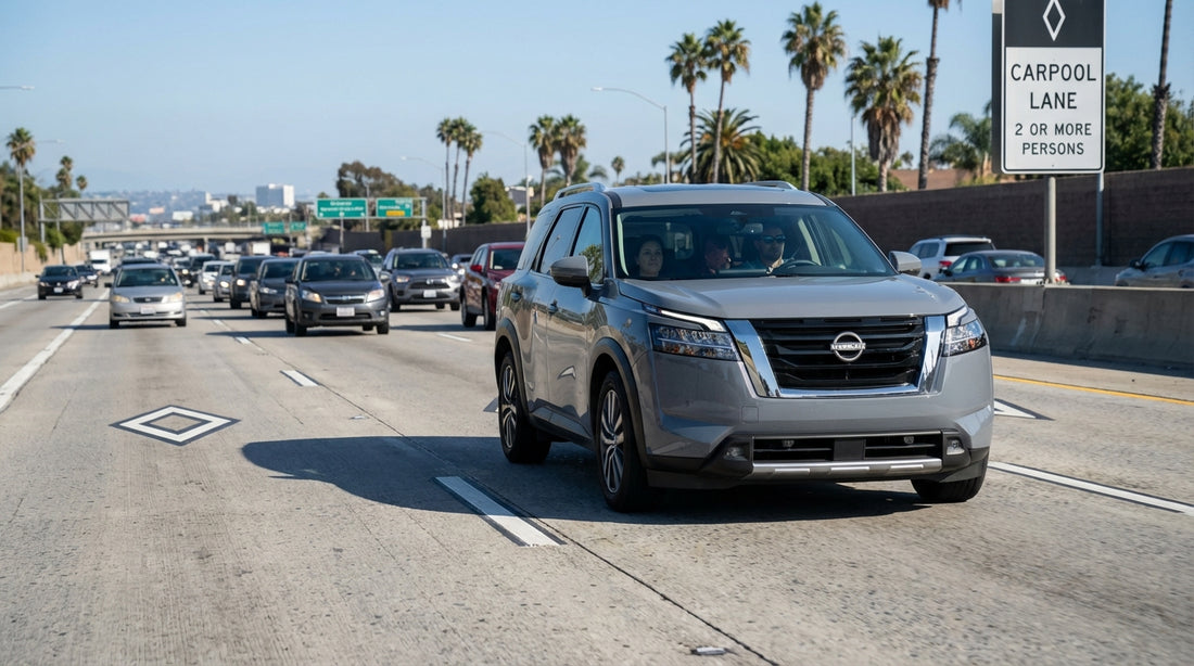 A silver car hire driving in the carpool lane on a sunny Los Angeles freeway surrounded by palm trees