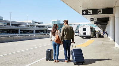 A traveler is dropped off by a taxi at the SFO car rental center in San Francisco