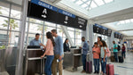 Travelers waiting in a car rental queue at shared counters inside the Las Vegas airport
