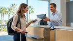 Traveler showing a passport to an agent at an Orlando car rental counter