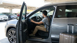 Driver checking the dashboard lights of a modern car rental before a road trip through the Arizona desert