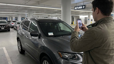 A quiet car hire return lot at Orlando airport at night, with a row of parked sedans and SUVs