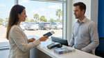 A person at a Texas airport counter shows their driver's license and passport for their car hire