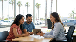 Person handing over car keys at a car rental counter in California