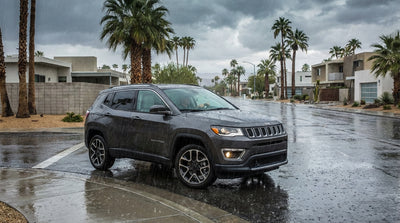 A white car hire navigating a flooded Las Vegas street with dark monsoon clouds overhead