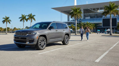 A driver parks their car hire in a lot with a clear view of Hard Rock Stadium in Miami on a bright, sunny day