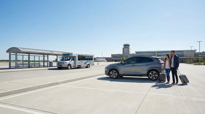 A traveler at a car hire counter inside a busy United States airport asking for keys to their vehicle