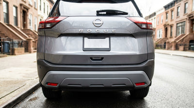 Rear view of a car hire in New York with a license plate frame covering the state name