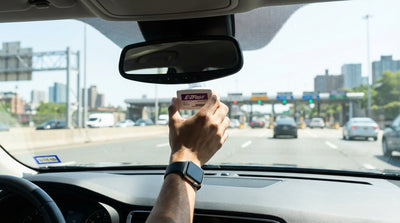 A car hire driving towards a bridge toll plaza with the modern New York City skyline in the background