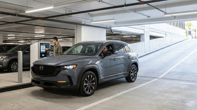 A modern car rental at the entrance gate of a concrete New York parking garage