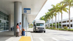 Hola car hire shuttle bus parked outside the arrivals terminal at Miami Airport