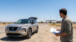White car rental driving on a long desert highway in Texas under a clear blue sky