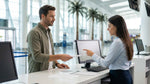 A person at an Orlando airport counter discusses their car hire booking details with an agent