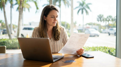 A police car pulls over a car hire vehicle on a sunny Florida highway lined with palm trees