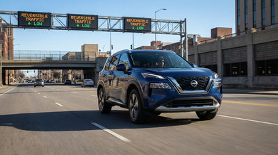 A car rental drives under green arrow signals on a reversible lane on a busy street in Pittsburgh, Pennsylvania