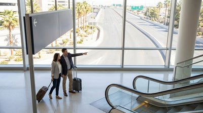 A blue and white shuttle bus for the car rental center waiting for passengers at the Las Vegas airport terminal