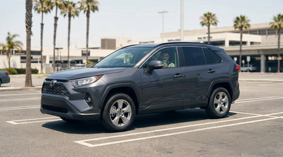 A driver in a car hire vehicle waits at the busy arrivals terminal of LAX in Los Angeles for a passenger pickup