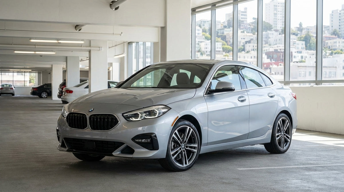 A red convertible car rental driving over the Golden Gate Bridge in San Francisco on a sunny day