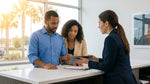 Close-up of a person signing car rental documents at a customer service desk in Orlando
