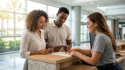 A customer reviews paperwork with car keys on an Orlando car rental counter