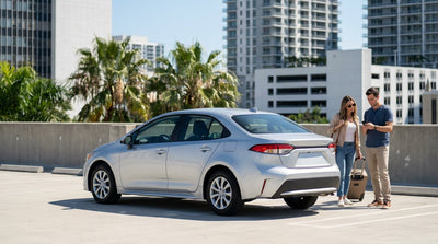 A red car hire convertible driving down a sunny, palm-lined street in downtown Orlando