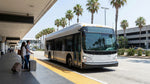 A car hire shuttle bus waits for passengers outside the LAX airport terminal in Los Angeles